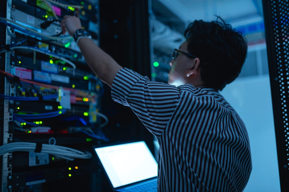 cybersecurity technician working on equipment